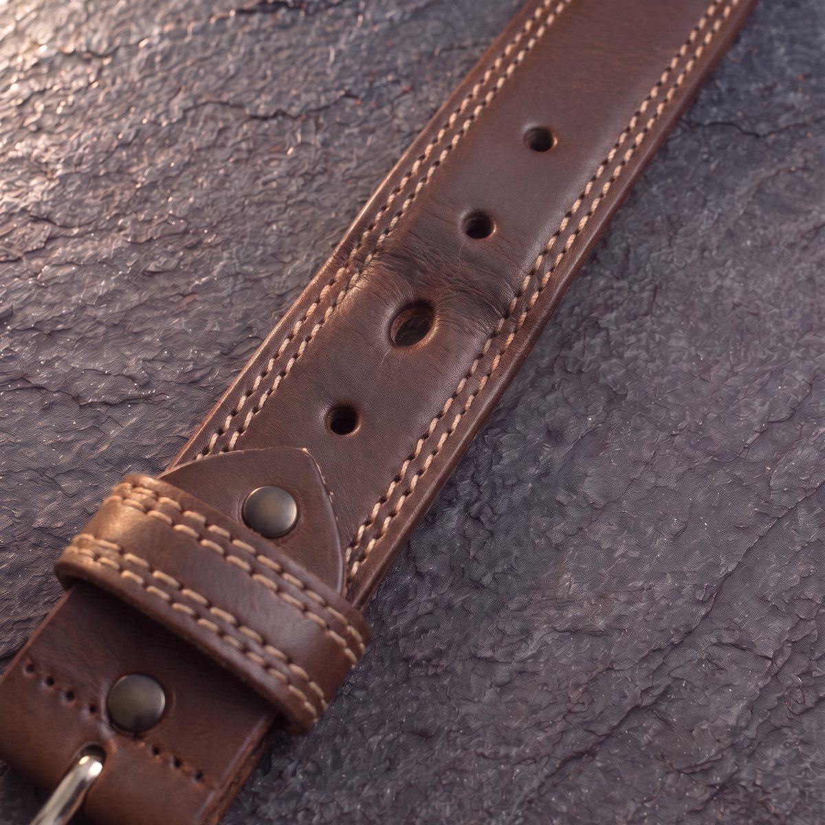 Our full-grain belt after one year of daily wear: broken in, still strong