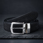 Black Stingray Belt, rolled, on dark slate