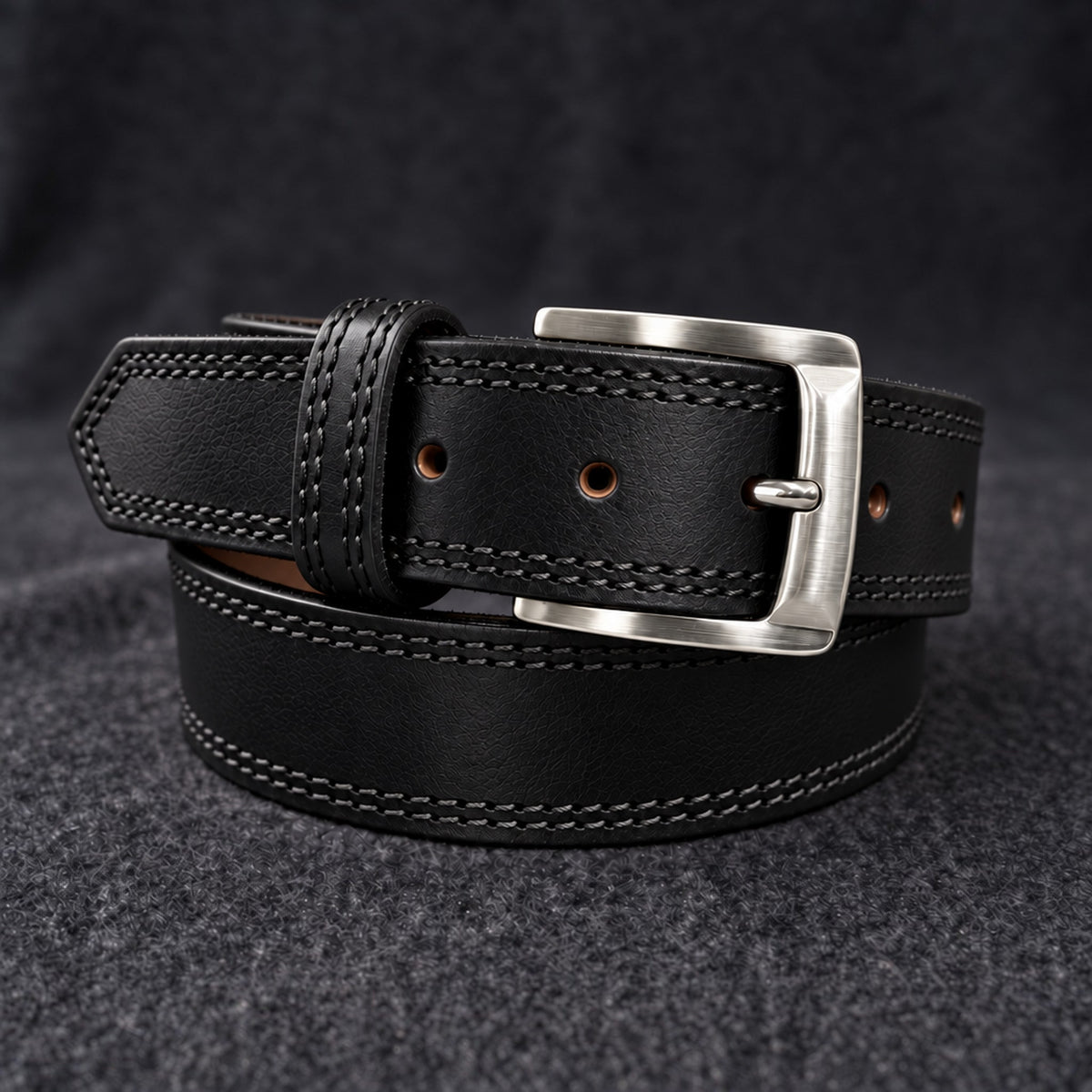 The Italian One-Piece belt in Black, coiled on charcoal wool [Black]