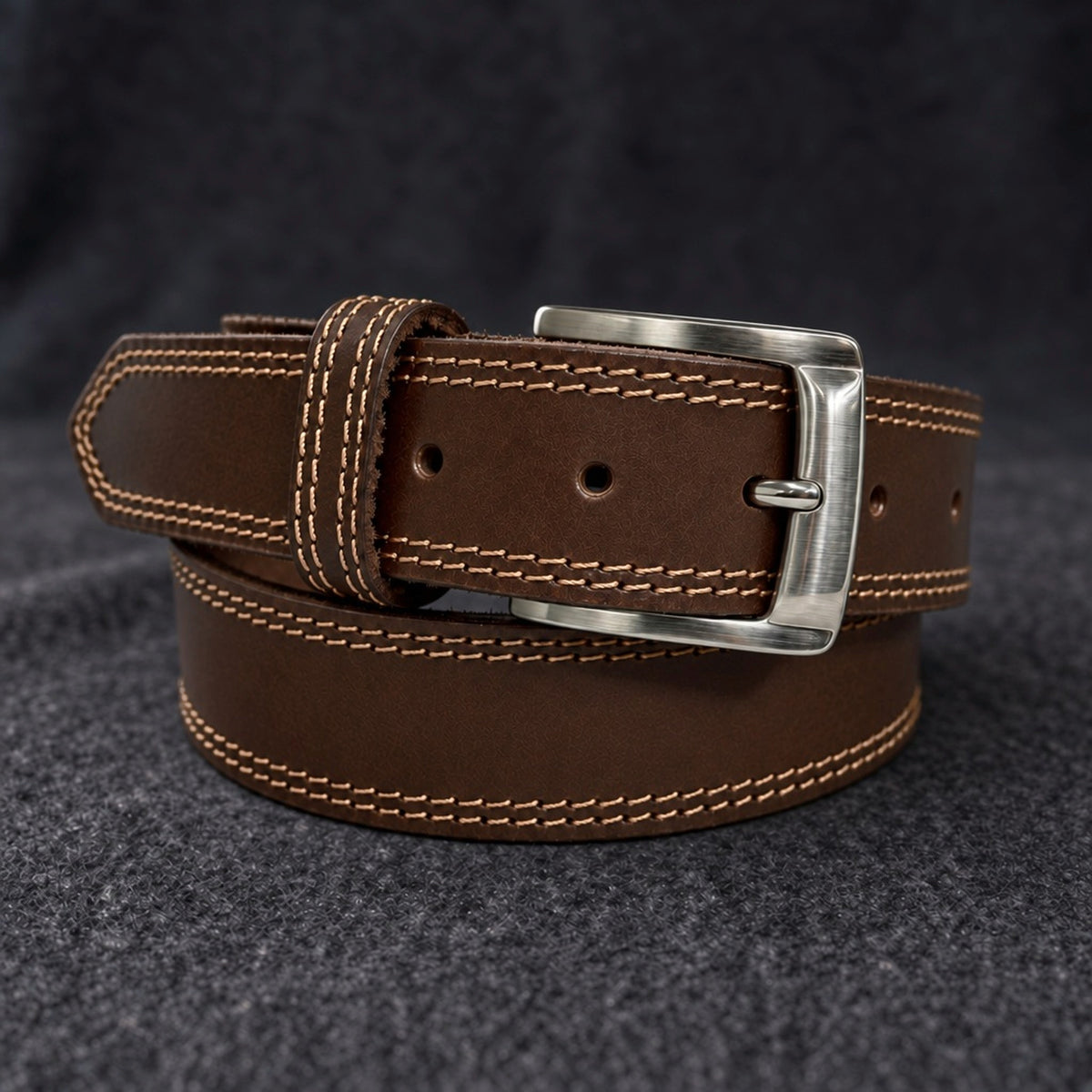 The Italian One-Piece belt in Brown, coiled on charcoal wool [Brown]
