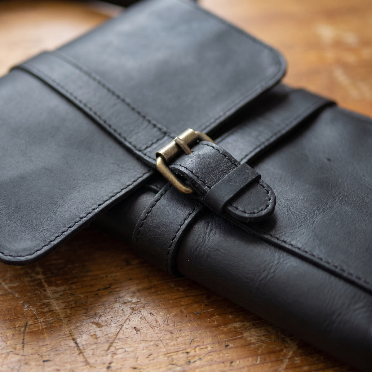 Buckle Messenger Satchel in Black, close-up of the hardware and stitching [Black]