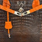 Crocodile Tote with Orange Trim, close-up of the crocodile grain and lock
