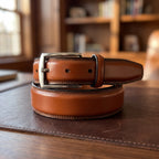 The Italian Dress Belt in Cognac, on a walnut executive desk [Cognac]