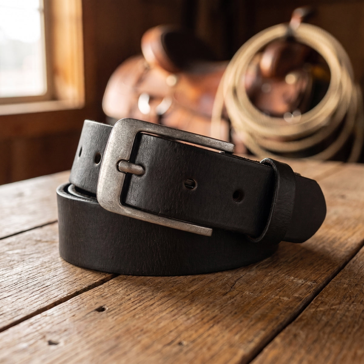 The Longhorn Belt in Black, on a ranch tack-room table [Black]