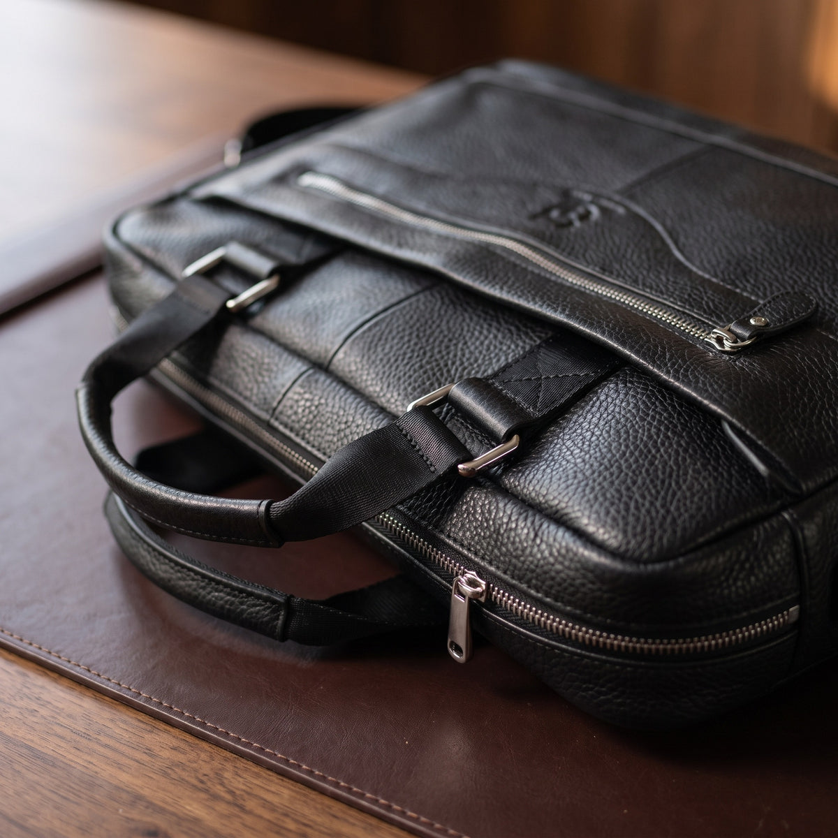 Pebbled Leather Briefcase in Black, close-up of the hardware and stitching [Black]