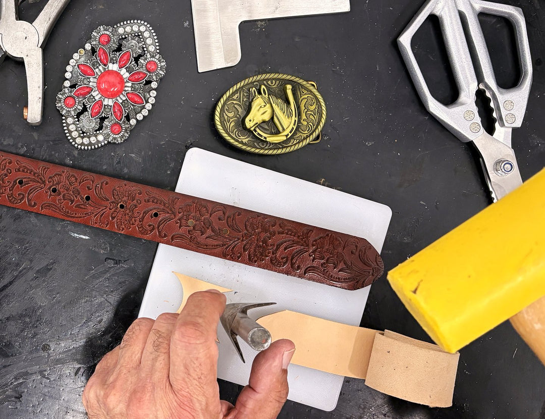 Fitting a new leather strap at the bench, with buckles and tools around it