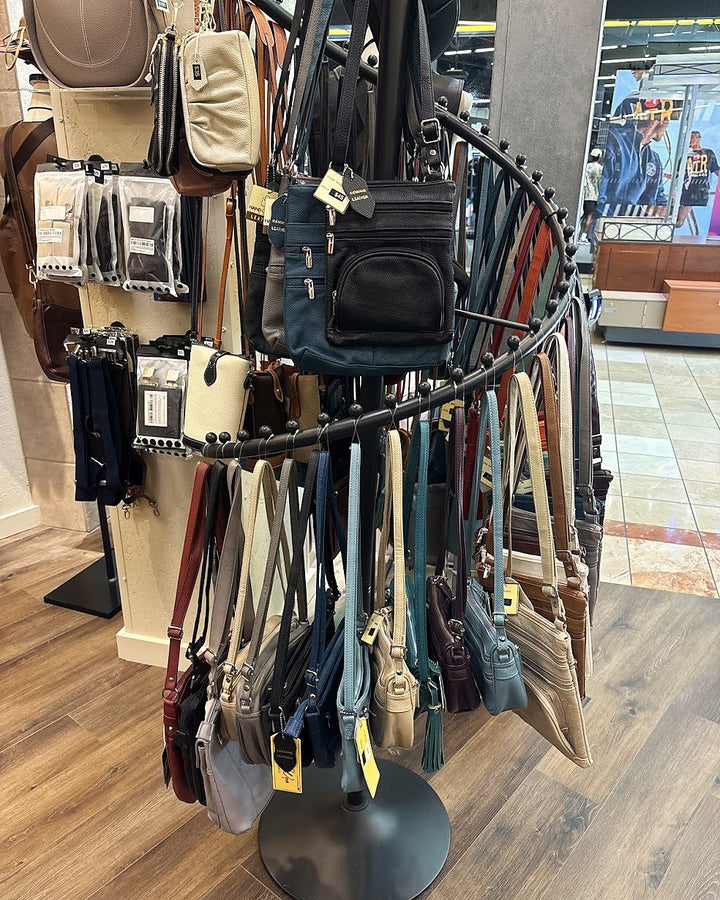 Leather crossbody and travel bags on the carousel