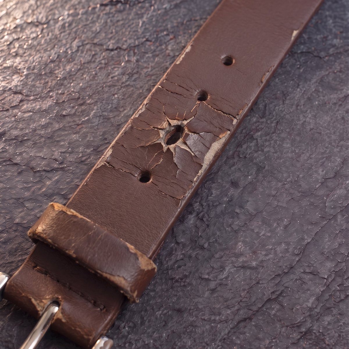 A department-store bonded belt after one year: cracked and peeling